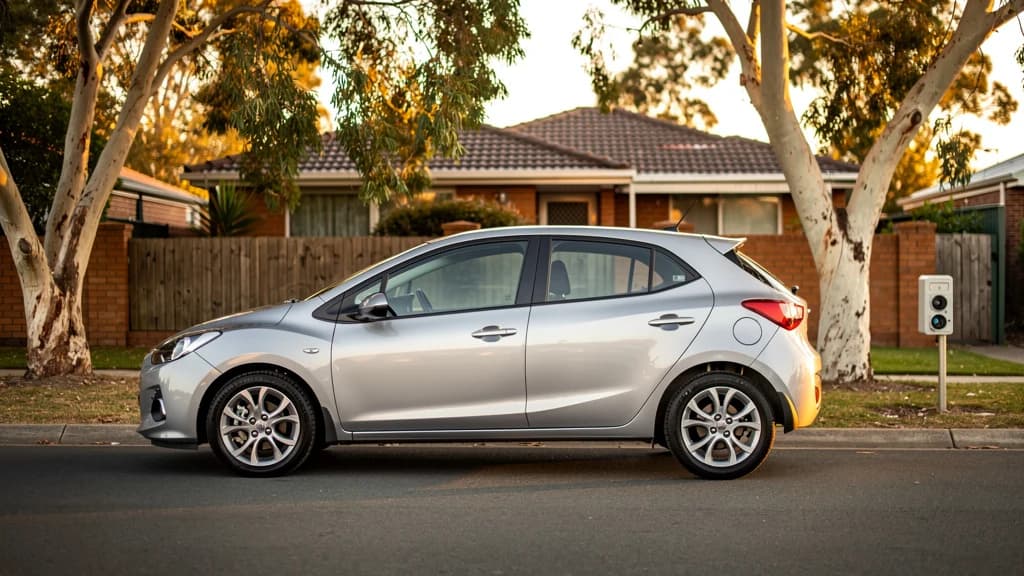 Silver hatchback parked on a quiet residential street in Craigieburn, surrounded by gum trees and brick homes.